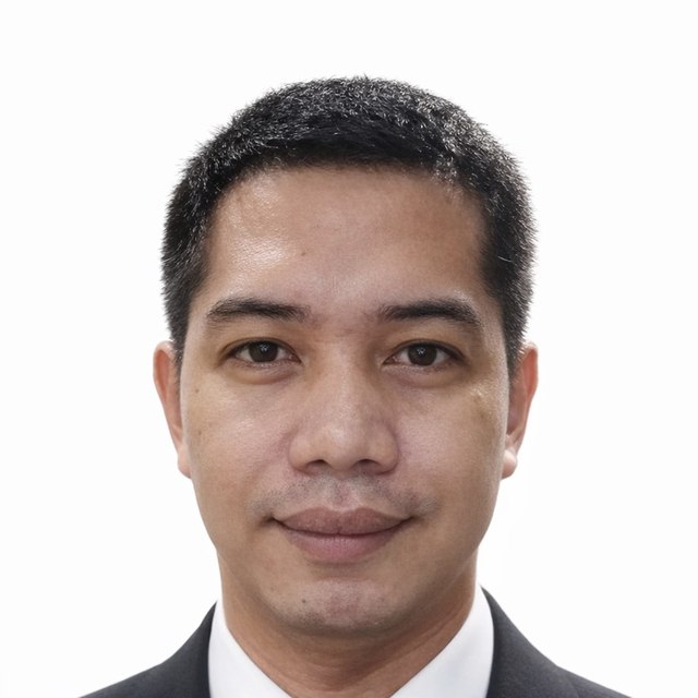 Portrait of Jerico Guanizo, wearing a dark suit and tie